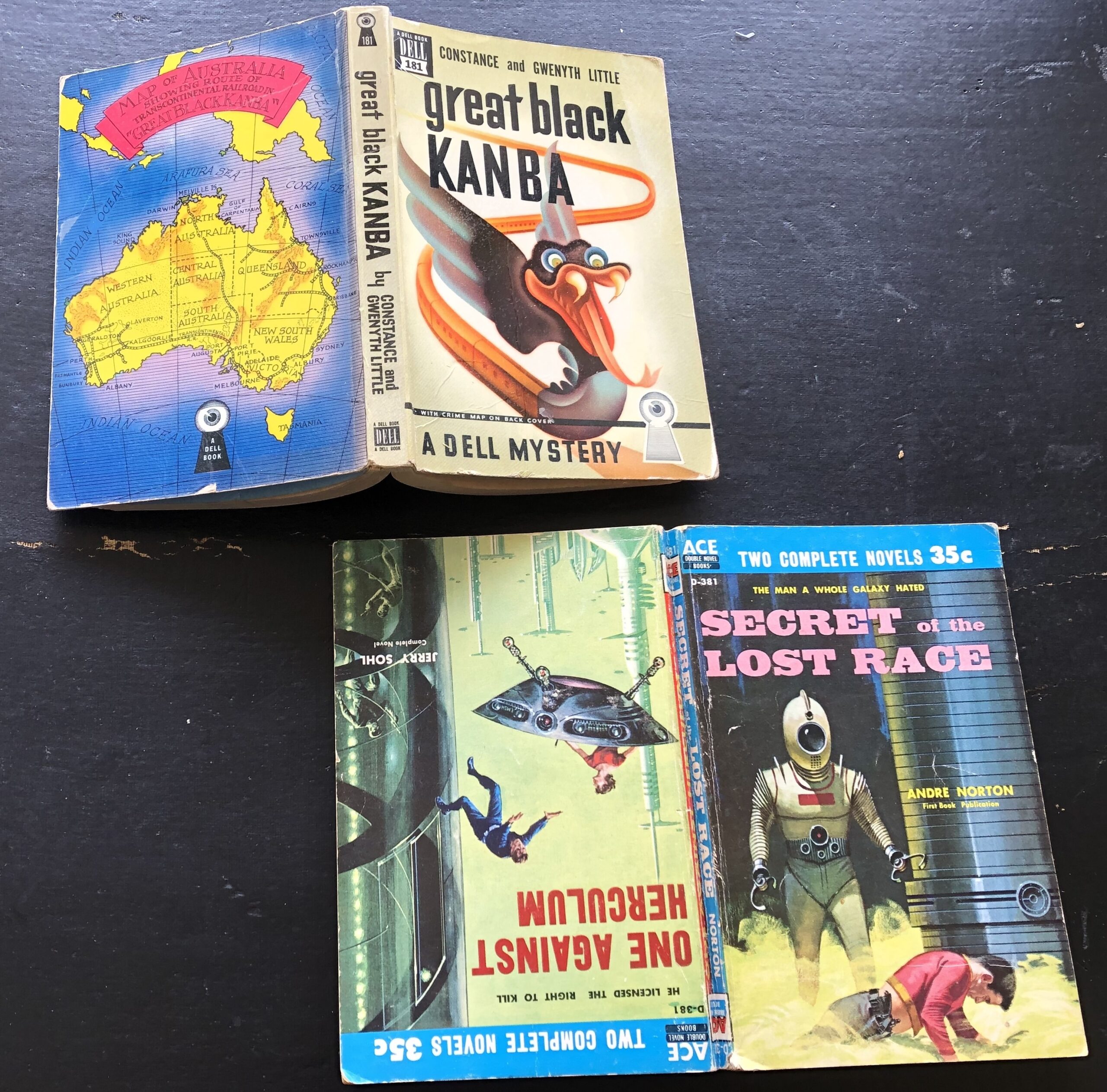 From left to right: Dell Mapback mystery with map of Australia on back, Great Black Kanaba by Constance and Gwenyth Little, 1944, cover art uncredited; and Ace Double, I Want the Stars by Tom Purdom and Demons’ World by Kenneth Bulmer, 1964, cover artists uncredited. Photo by Rosemary Jones, from the author’s collection.