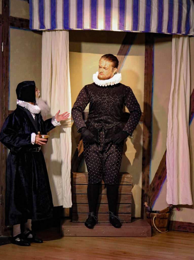 Photo of Zee Hanna as the Automaton and Jan Wallace as John Dee in Wonder of Our Stage by Monica Cross at the Players Centre, 2019. Directed by Candace Artim. Photo by Goddess Imagery.