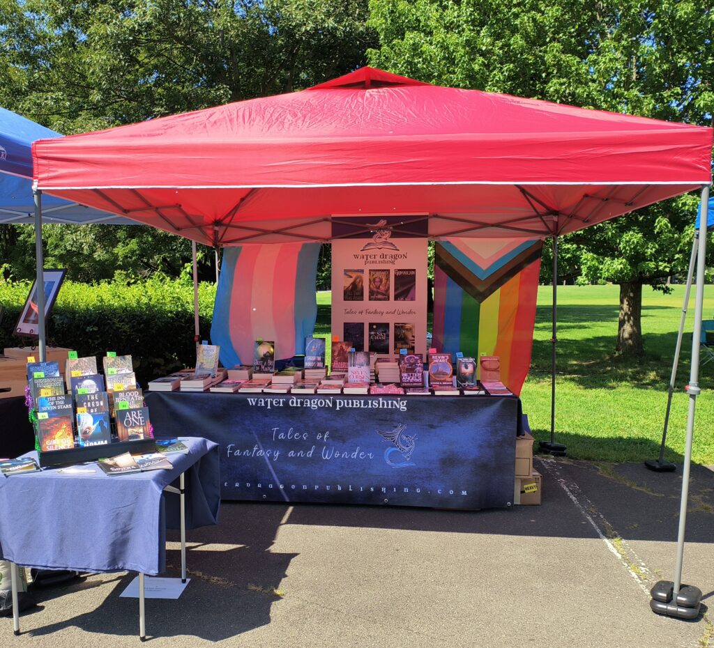 The author's vendor booth at the Rock, Roll, & Gather event for the Stavros Center for Independent Living at Look Park in Florence, Massachusetts, on August 2, 2025. 