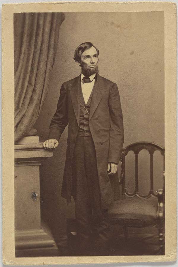 Sepia portrait of Lincoln standing by a chair, Smithsonian Institution from United States, via Wikimedia Commons